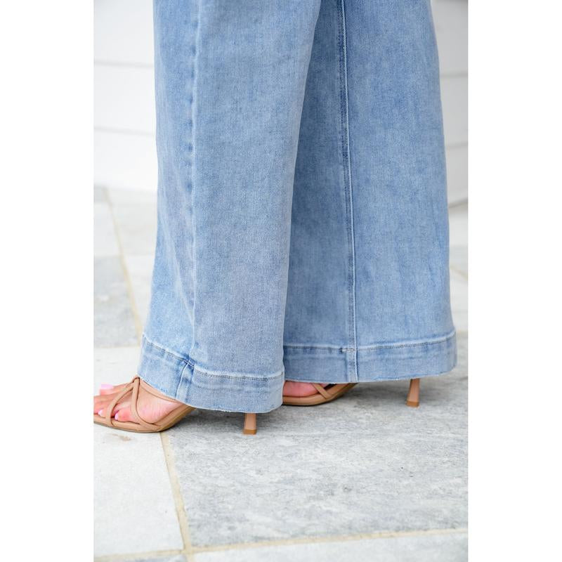 Risen High Rise Light Wash Wide Leg Jeans with Slanted Pockets